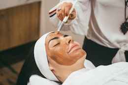 A treatment mask and headband during a facial